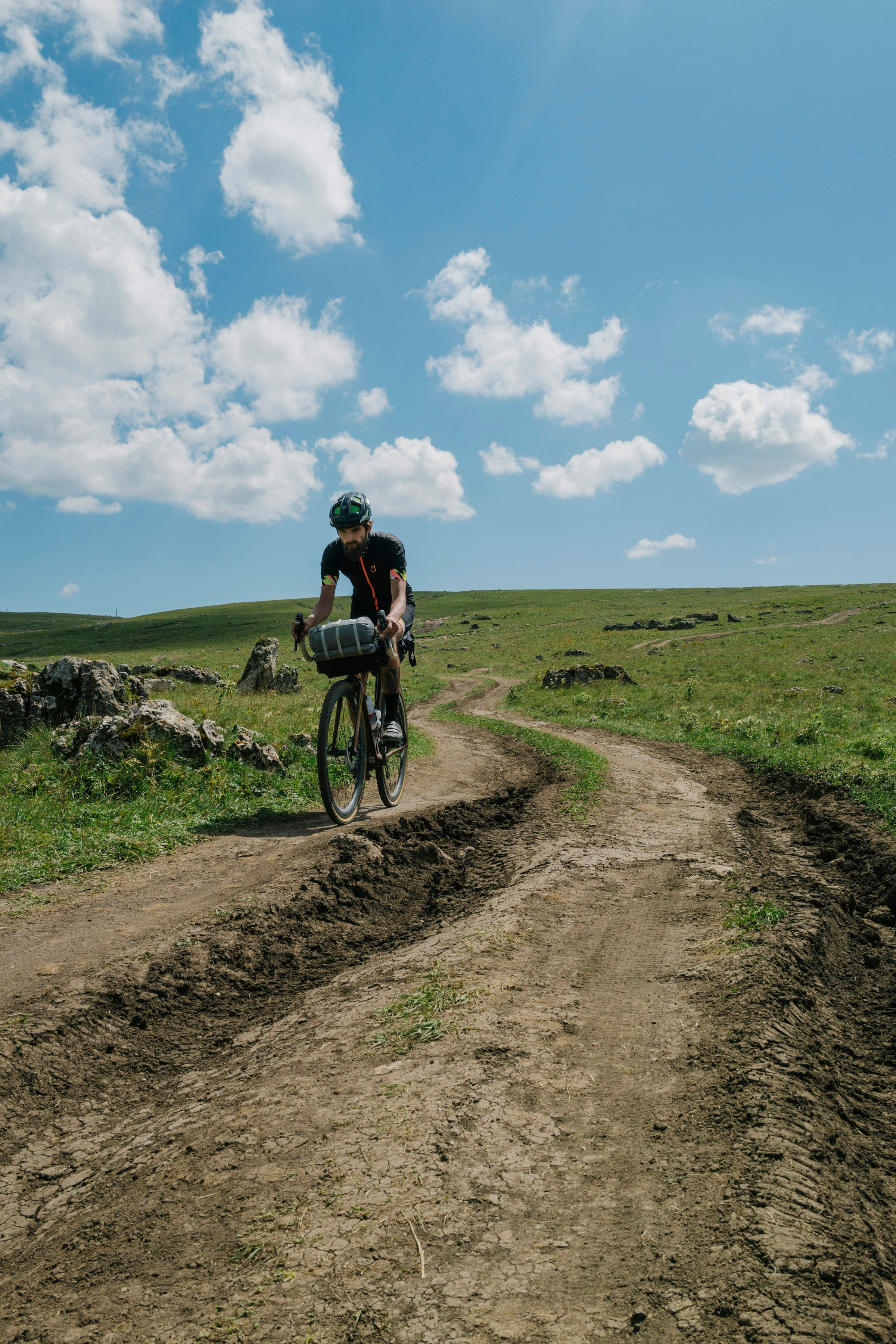 Cyclist riding along a gravel road